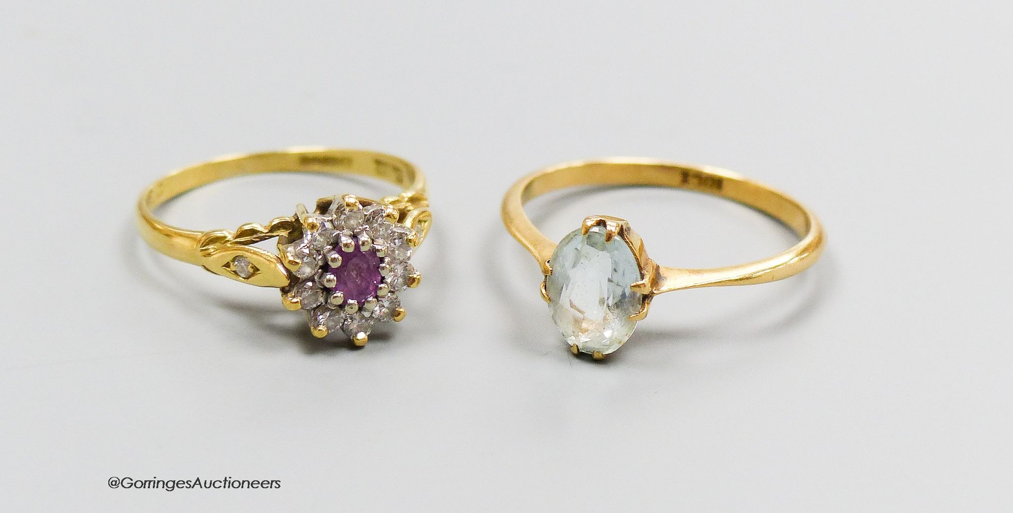 An 18ct gold diamond and pink stone cluster ring, size K and an 18ct gold and aquamarine ring, size M. Gross 4g.